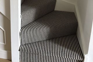 black and white cream striped stairs carpet on curved staircase